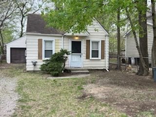 bungalow-style home featuring a garage and entry steps