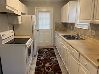 kitchen with electric stove, a sink, under cabinet range hood, light countertops, and washer / clothes dryer