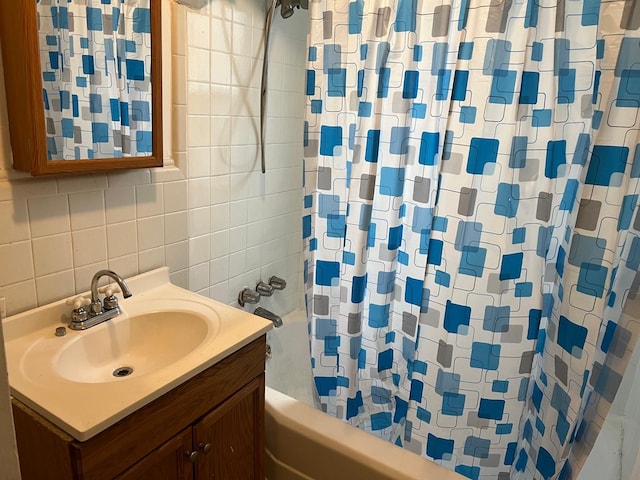 full bathroom with tile walls, backsplash, shower / bath combination with curtain, and vanity