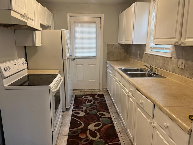 kitchen with electric stove, under cabinet range hood, plenty of natural light, and a sink