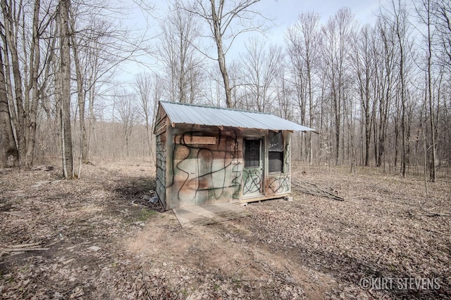 view of shed with a forest view