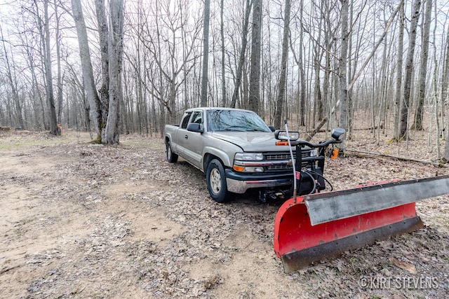 view of car parking with a wooded view