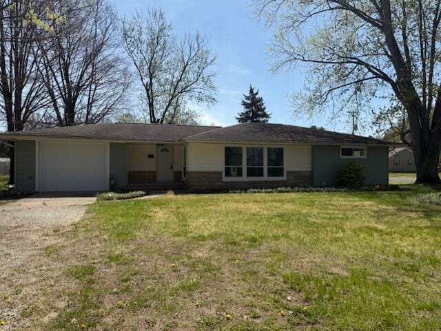 545 W Main St, Centreville, MI 49032 - ranch-style house featuring a front yard, dirt driveway, and an attached garage