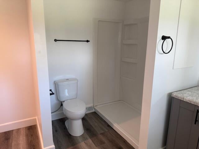 545 W Main St, Centreville, MI 49032 - full bath featuring vanity, toilet, a stall shower, baseboards, and wood finished floors