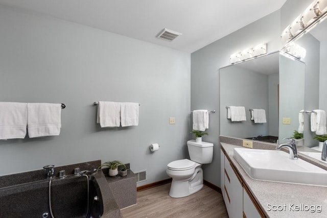full bath featuring visible vents, wood finished floors, toilet, and vanity