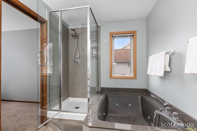 bathroom with a stall shower and a whirlpool tub