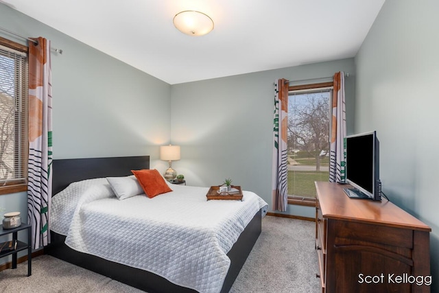 bedroom featuring carpet and baseboards