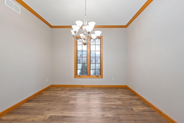 unfurnished room with wood finished floors, visible vents, ornamental molding, and a notable chandelier