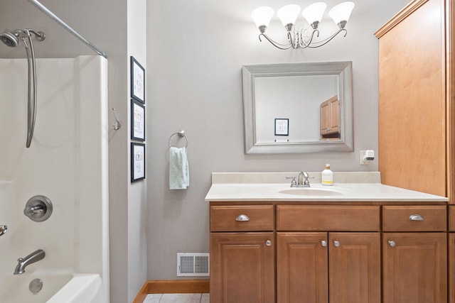 bathroom featuring an inviting chandelier, tile patterned flooring, vanity, baseboards, and visible vents