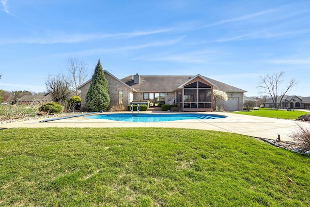 pool featuring a sunroom and a lawn
