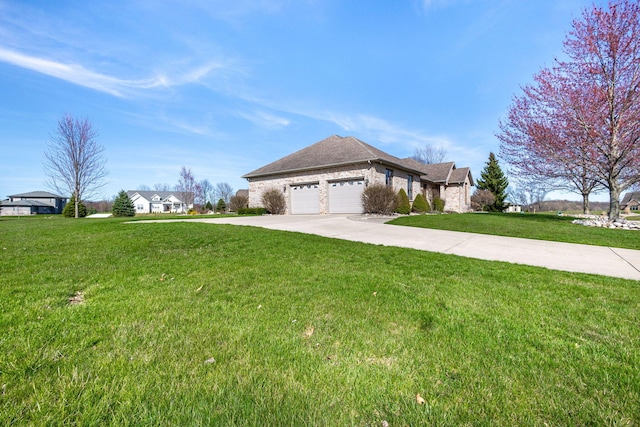 view of front of house featuring concrete driveway, a front lawn, and a garage