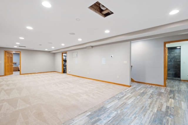 finished basement with recessed lighting, light wood finished floors, and baseboards