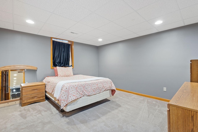 carpeted bedroom featuring recessed lighting, a paneled ceiling, visible vents, and baseboards
