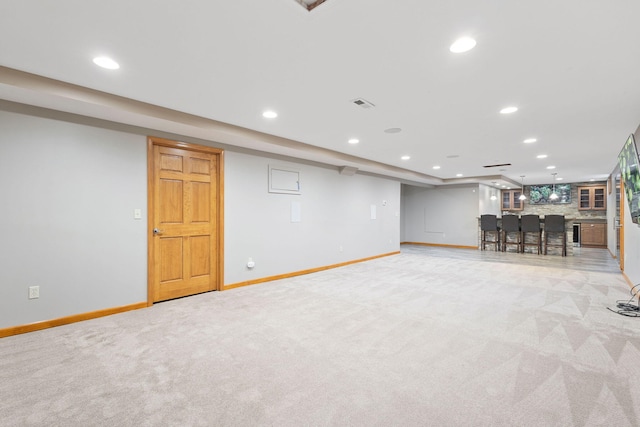 finished below grade area with recessed lighting and light carpet