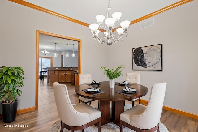 2776 W Hogan Dr, Indiana, IN 46350 - dining space featuring a chandelier, light wood-style flooring, and crown molding
