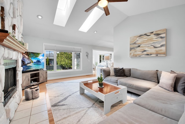 73941 Madison St, Armada, MI 48005 - living room with a ceiling fan, a large fireplace, light wood finished floors, lofted ceiling with skylight, and recessed lighting