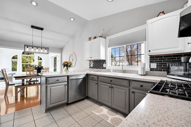 73941 Madison St, Armada, MI 48005 - kitchen featuring lofted ceiling, dishwasher, a sink, light tile patterned floors, and gray cabinetry