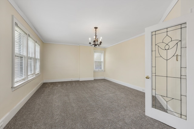 carpeted spare room featuring ornamental molding, a notable chandelier, and baseboards