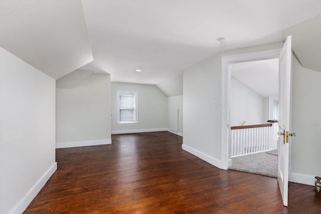 bonus room with vaulted ceiling, hardwood / wood-style flooring, and baseboards