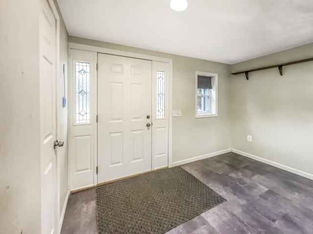 entrance foyer featuring baseboards and dark wood-style flooring