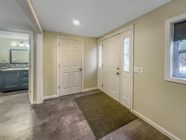 foyer entrance featuring baseboards