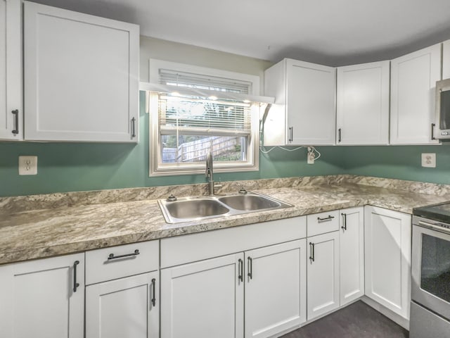 kitchen featuring a sink, white cabinets, and stainless steel appliances