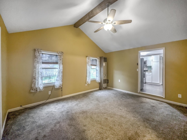 unfurnished room featuring a healthy amount of sunlight, ceiling fan, lofted ceiling with beams, and carpet flooring