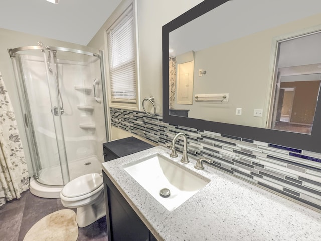 full bath featuring vanity, toilet, tasteful backsplash, and a stall shower