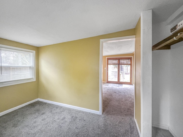 unfurnished room featuring baseboards and carpet flooring