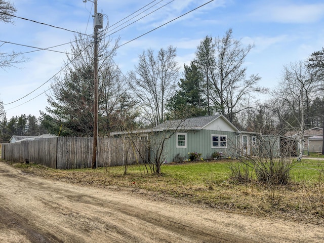 view of side of home with fence