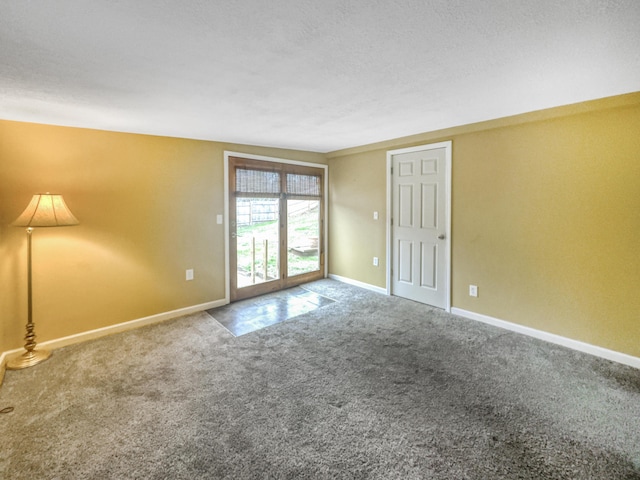 empty room with carpet floors and baseboards