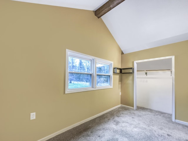 unfurnished bedroom with carpet flooring, baseboards, lofted ceiling with beams, and a closet