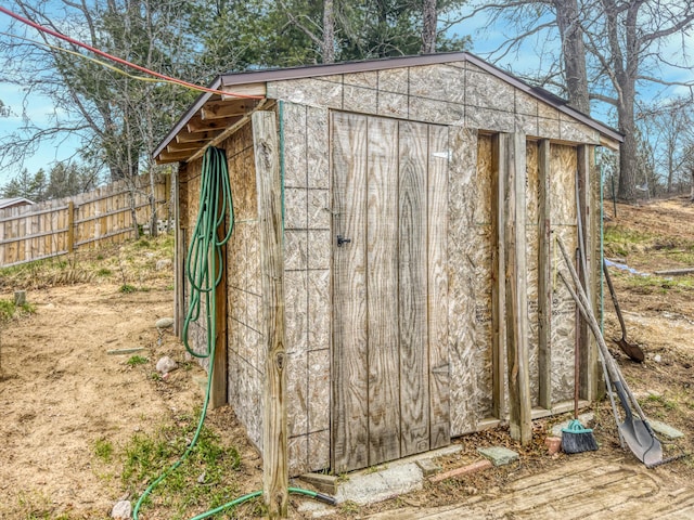 view of shed featuring fence