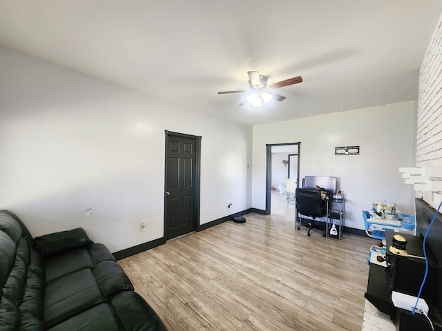 office space featuring light wood-style floors, a ceiling fan, and baseboards