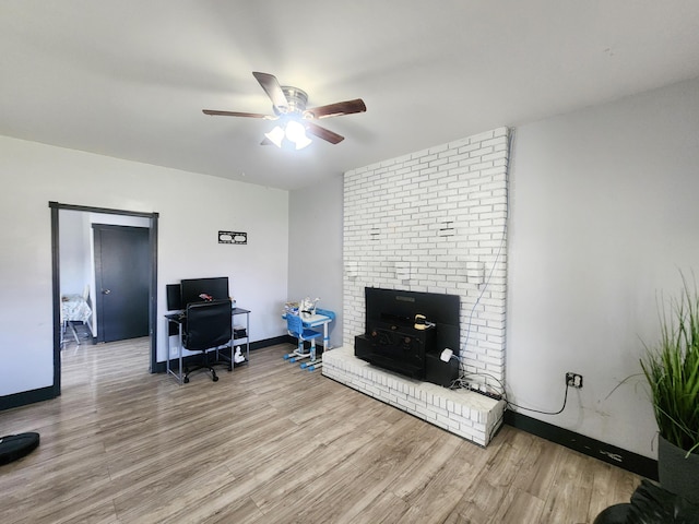 home office featuring baseboards, wood finished floors, and a ceiling fan