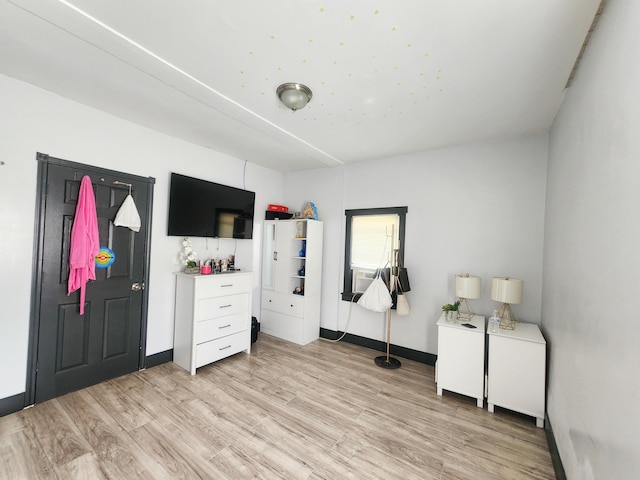 bedroom with light wood-style floors and baseboards