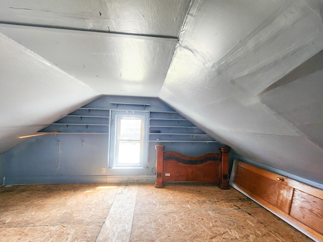 bonus room with a textured ceiling and lofted ceiling