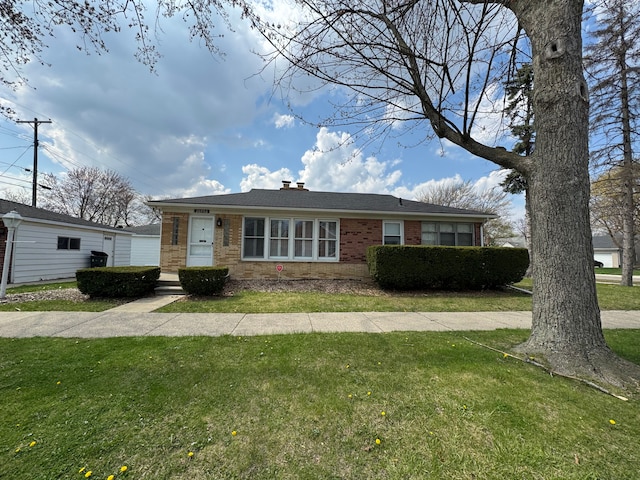 20950 Norwood Dr, Harper Woods, MI 48225 - view of front of property with a chimney, a front lawn, and brick siding