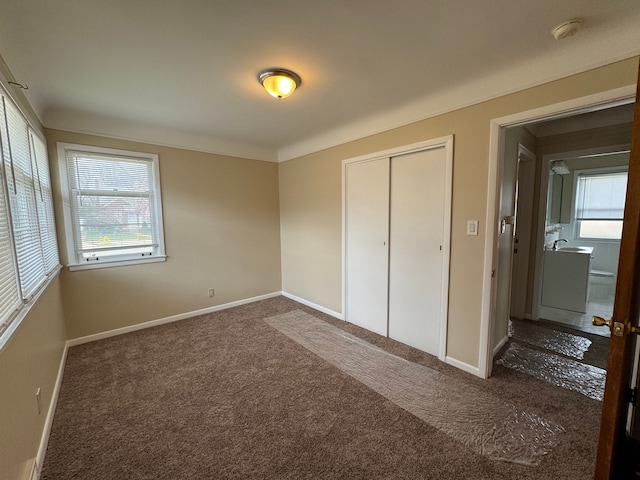 20950 Norwood Dr, Harper Woods, MI 48225 - unfurnished bedroom with baseboards, carpet, and a closet