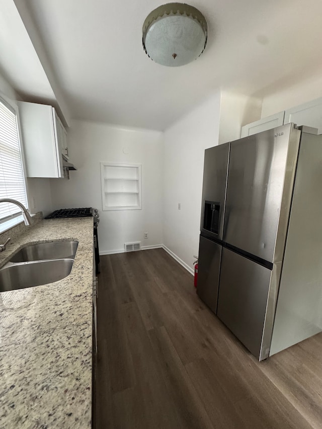 20950 Norwood Dr, Harper Woods, MI 48225 - kitchen featuring stainless steel refrigerator with ice dispenser, visible vents, a sink, dark wood-style floors, and white cabinetry