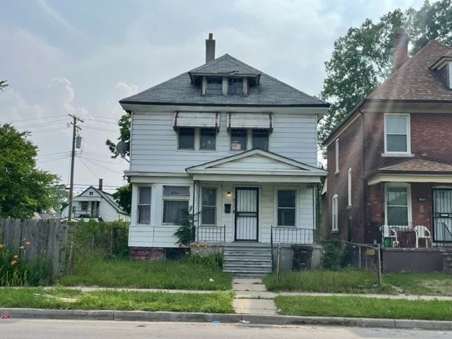 3015 Van Dyke St, Detroit, MI 48214 - traditional style home with fence private yard, covered porch, and a chimney