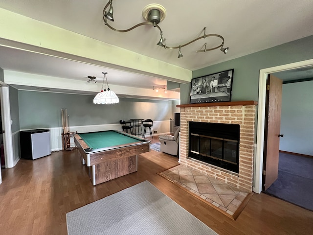 recreation room with beam ceiling, billiards, a fireplace, and wood finished floors