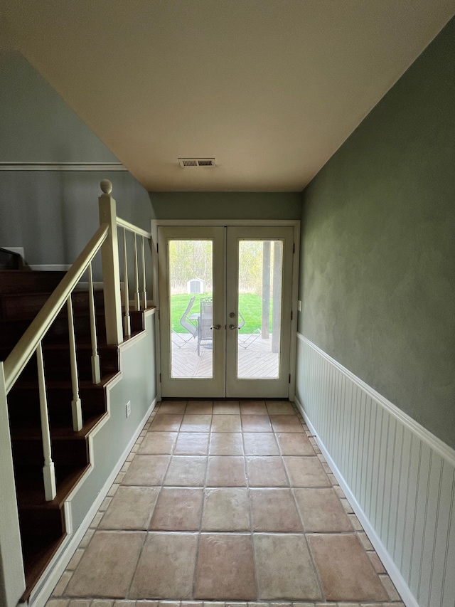 entryway featuring french doors, visible vents, stairway, baseboards, and light tile patterned flooring