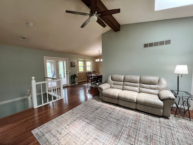 living area with visible vents, lofted ceiling with beams, wood finished floors, and ceiling fan with notable chandelier
