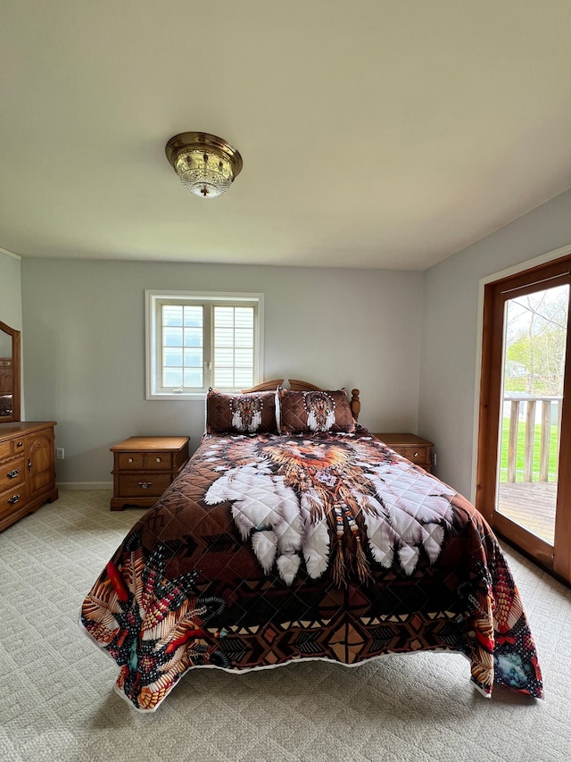 bedroom featuring access to outside and light carpet