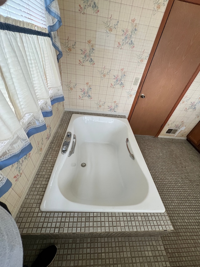 full bath with a relaxing tiled tub