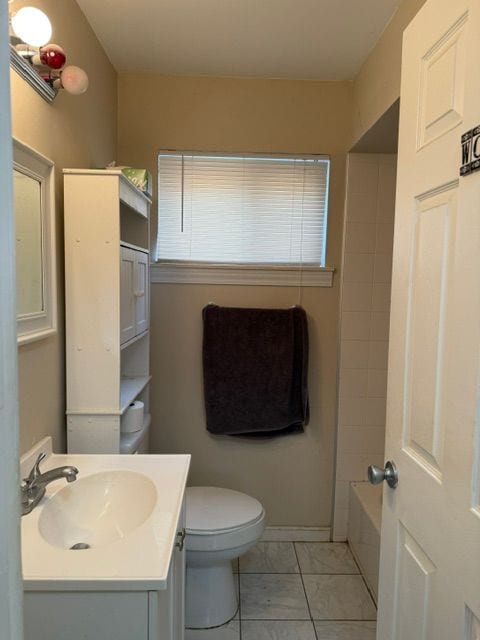 full bathroom featuring vanity, a wealth of natural light, toilet, and marble finish floor