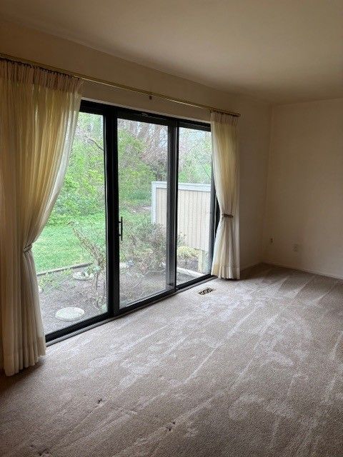carpeted spare room with visible vents