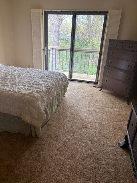 carpeted bedroom featuring access to outside