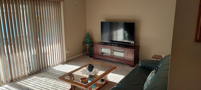 living room featuring carpet and baseboards